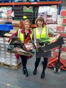 Ali Russell, CEO of The National Benevolent Charity and Phoebe Ruxton, Communications Manager at FareShare South West holding boxes of surplus food.