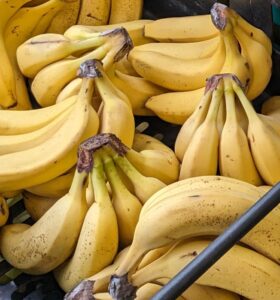 A few bunches of bananas in a black crate