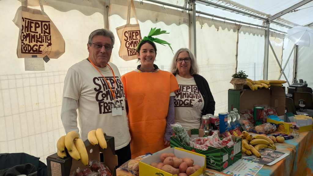 Shepton Community Fridge's stall at the festival, including a team member dressed as a carrot!